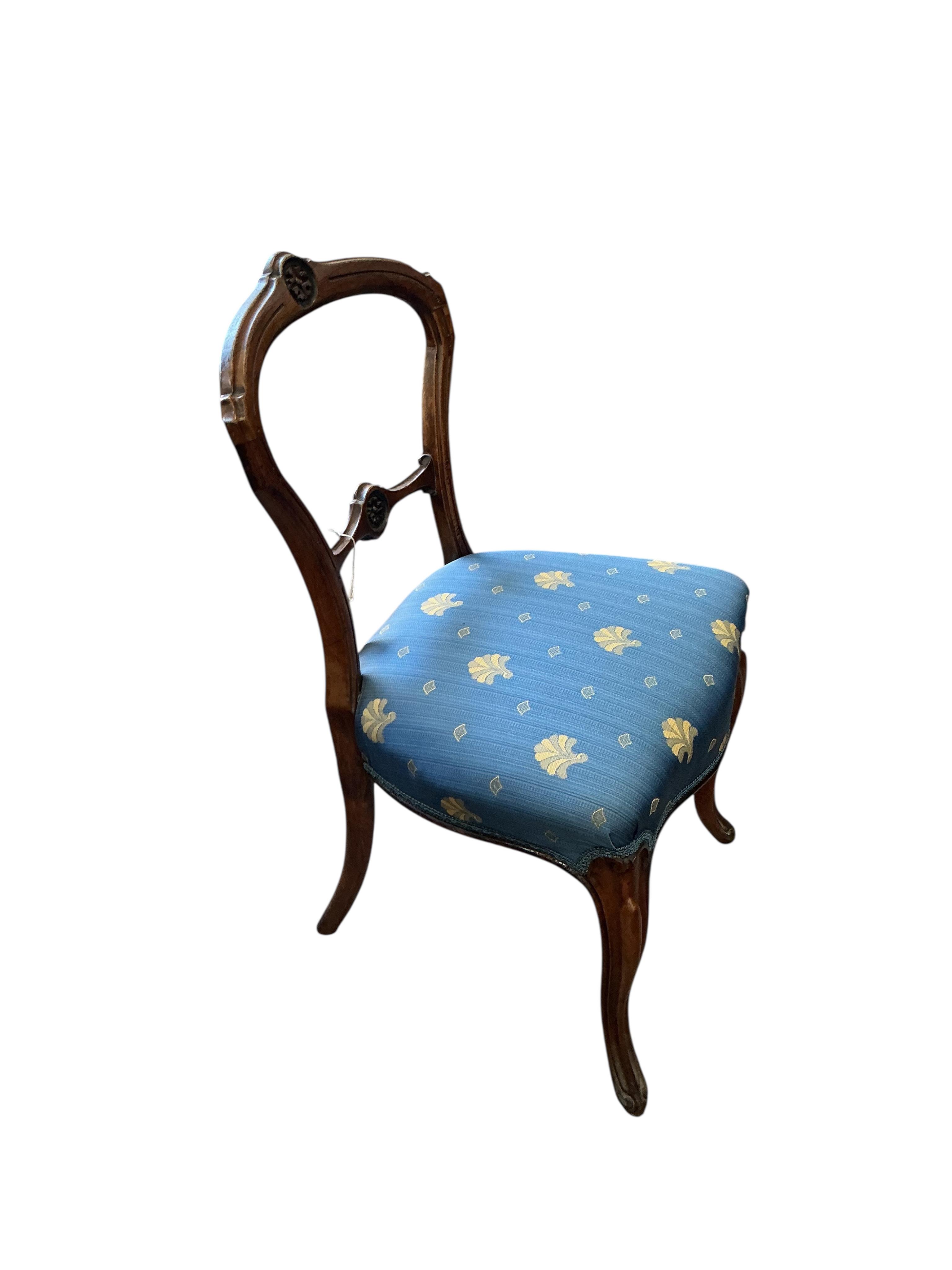 A set of six Victorian walnut balloon back dining chairs